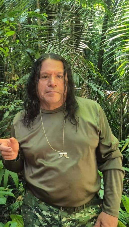 Héctor Vargas standing among lush Amazon rainforest foliage